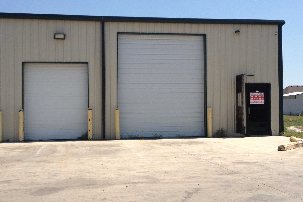 An image representing a warehouse with two adjacent rolling shutter doors 
